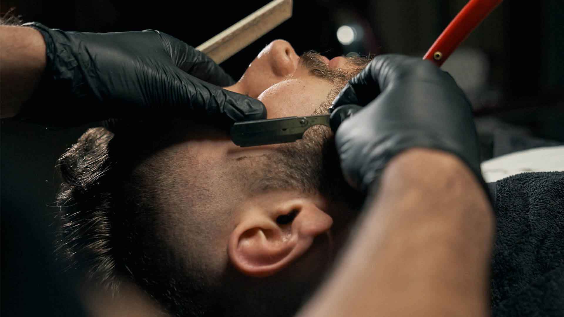 Barber shaping a fresh fade at Harbor and Steel